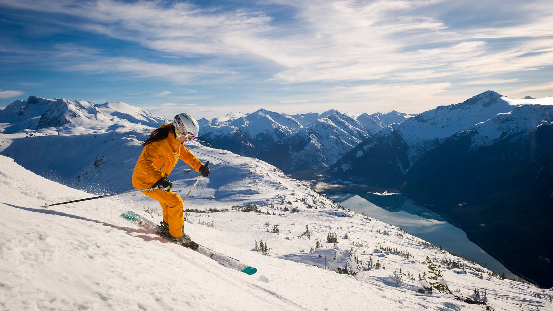Woman skis groomed runs at ski resort 