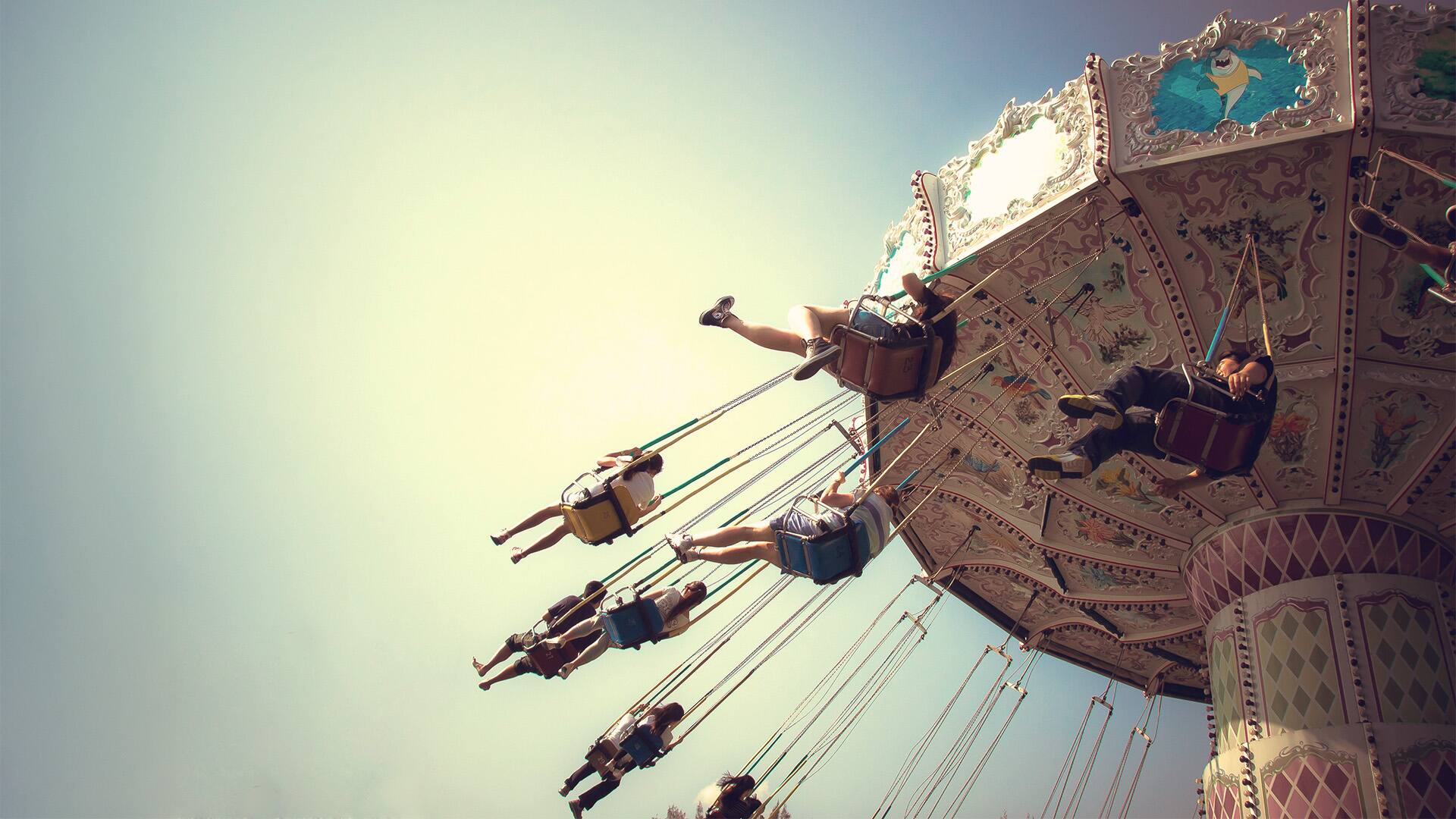 People playing swing carousel in amusement park