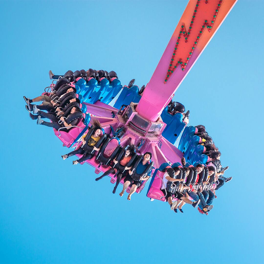 People having fun on The Flash in theme park