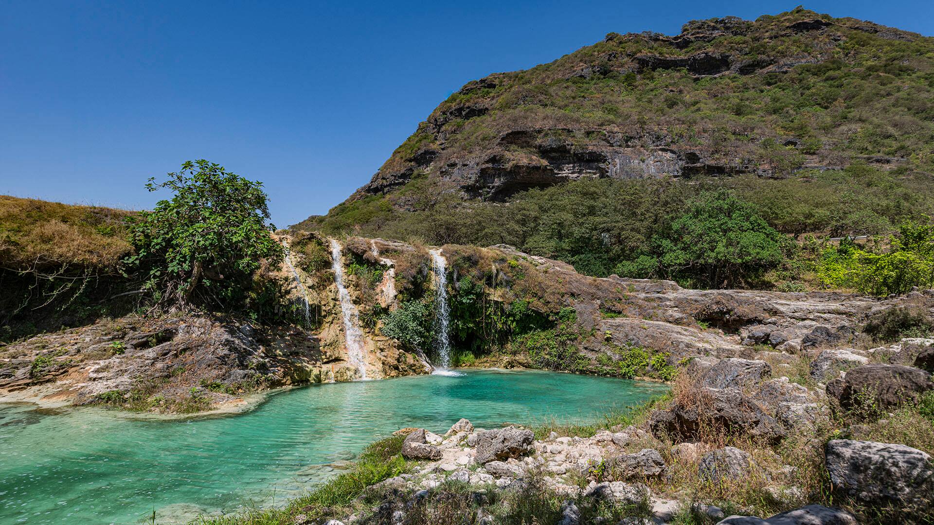 Oman, Dhofar, Salalah, Turquoise pond and waterfalls of Wadi Darbat river