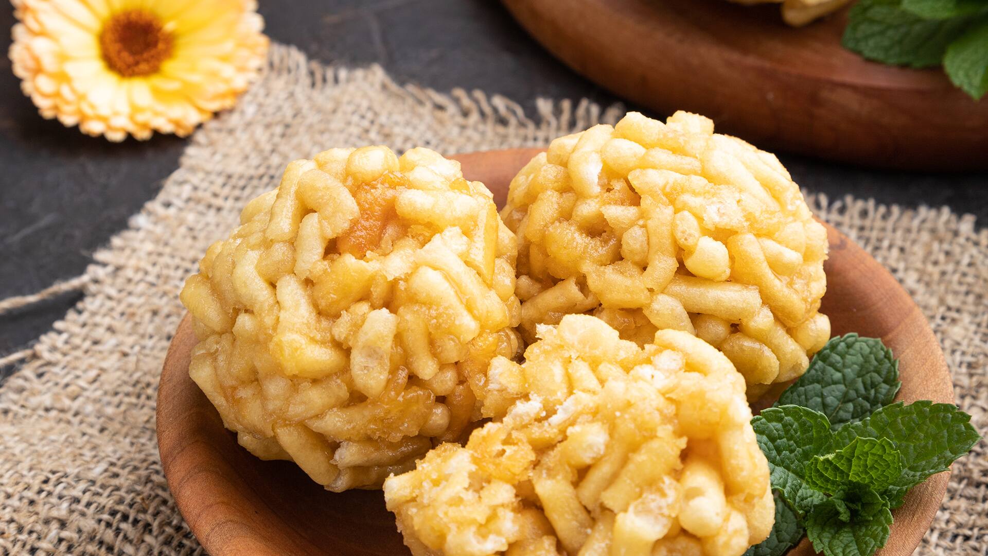 Traditional Tatar candy chak-chak made of dough and honey with cup of coffee on a black concrete background and linen textile