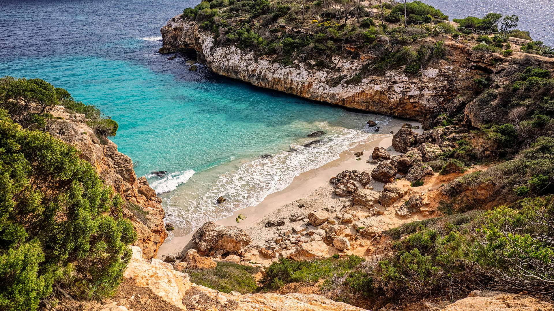 Elevated view of a small, unspoiled beach between the mountains. Cala del Moro, Mallorca