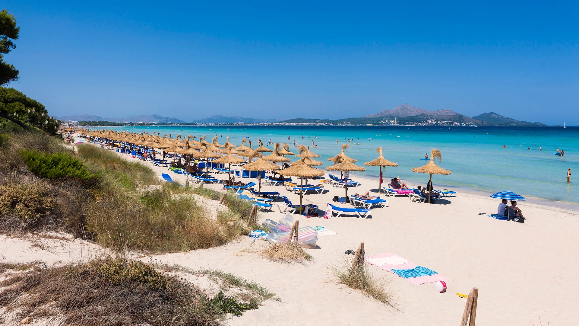Spain, Mallorca, View of tourists in Playa de Muro beach 