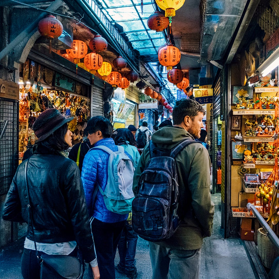 Mixed race couple shopping in outdoor Asian Market