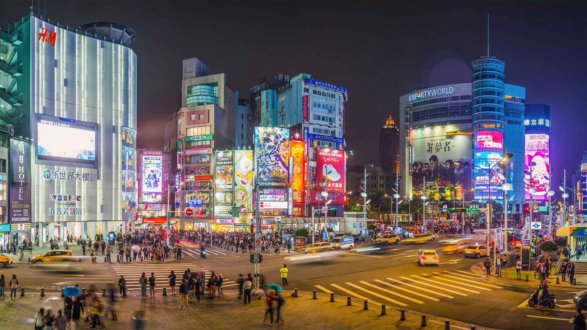 Taipei Ximen neon billboards Ximending shopping district night panorama Taiwan