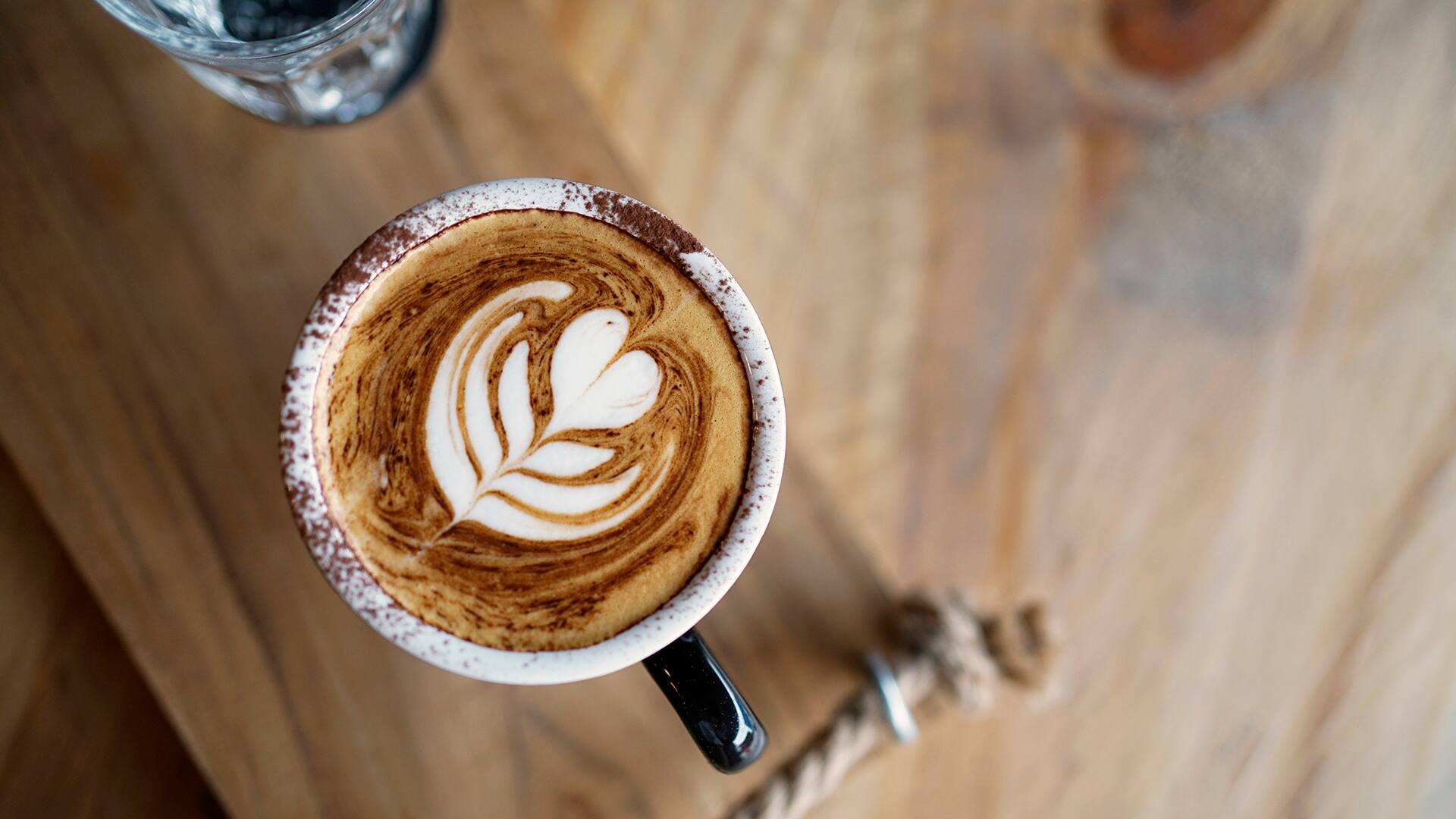 Top view of Hot coffee on wooden table copyspace