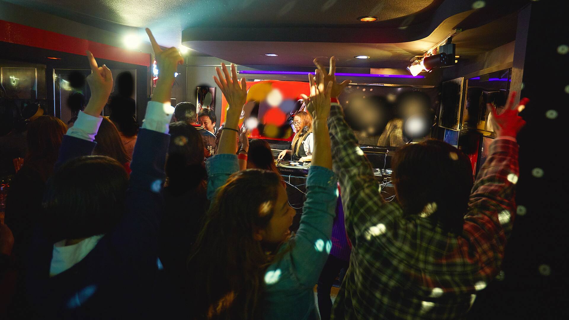 Crowd of people at Funky Night Party waving arms in the air