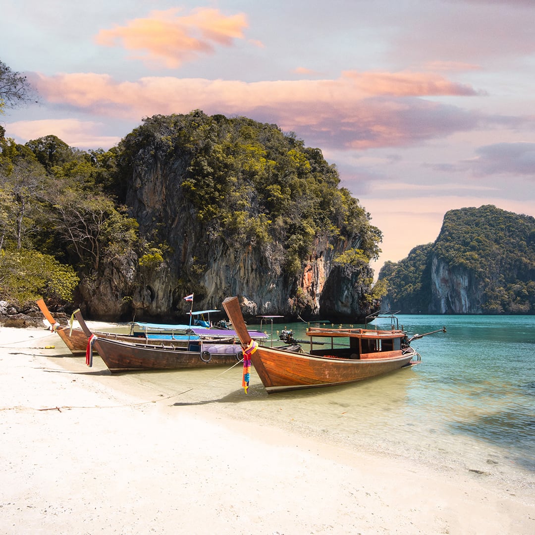 Long tail boat on koh lao la ding beach in Krabi during a sunny day