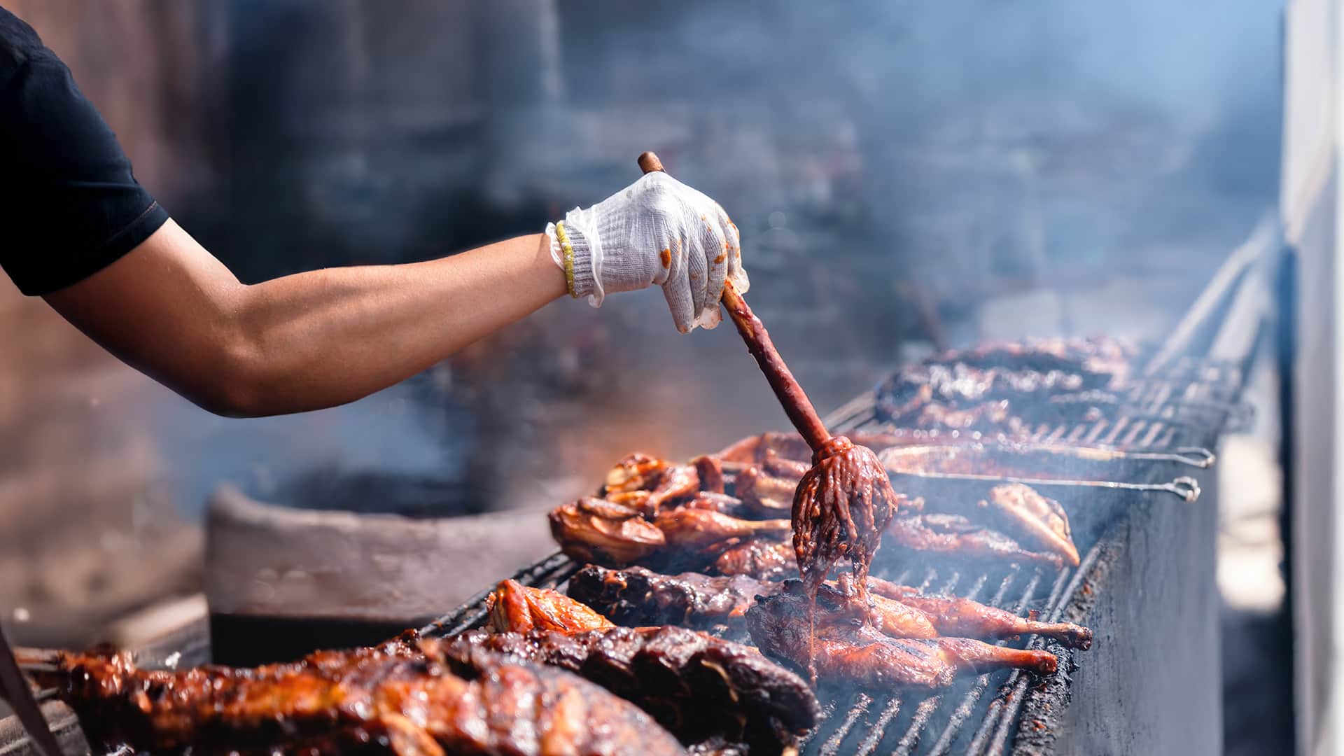 Gloved Hand Grilling Barbecue Chicken