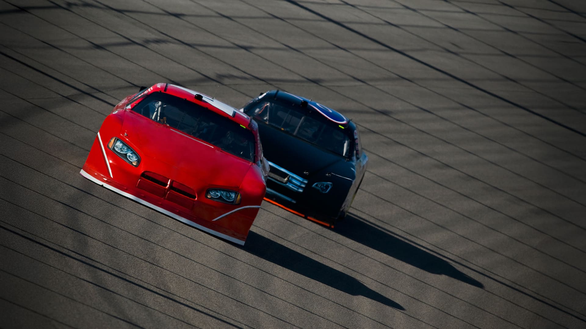 Stock cars racing around track