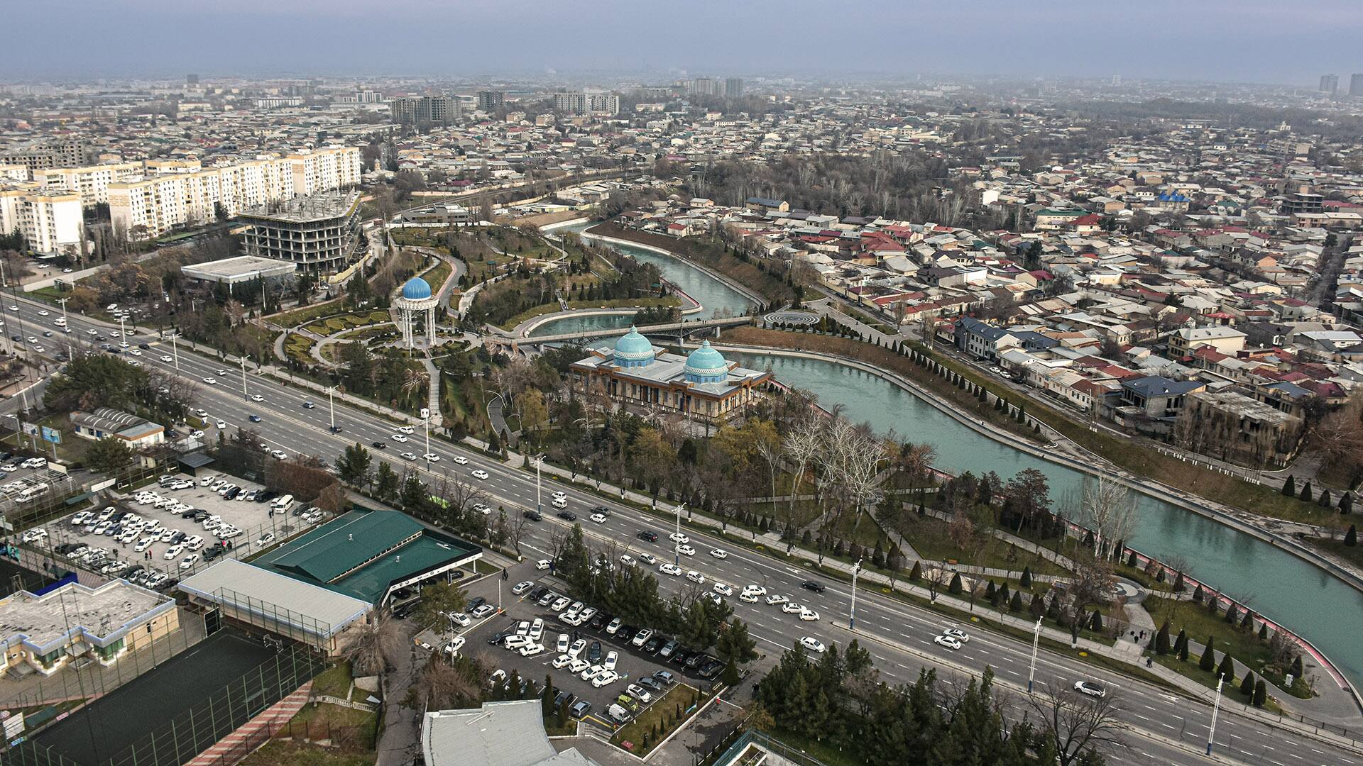 Aerial skyline and cityscape of Tashkent with "Alisher Navoi Park" and "Alley of writers" visible in the foreground in Uzbekistan
