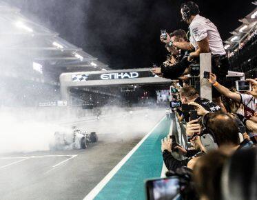 racing cars approaching the finish line in yas Marina circuit