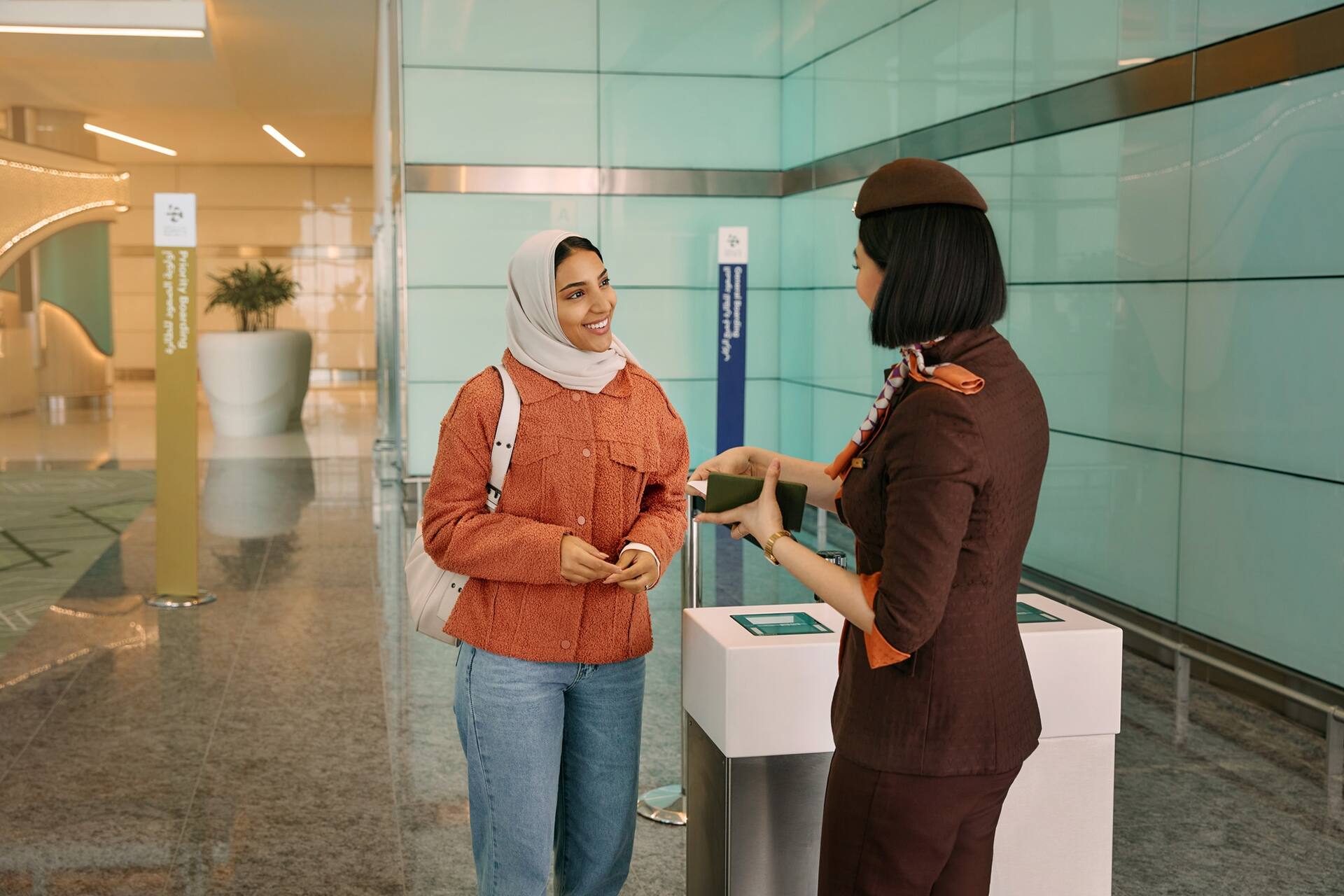 Etihad guest at boarding gate with crew