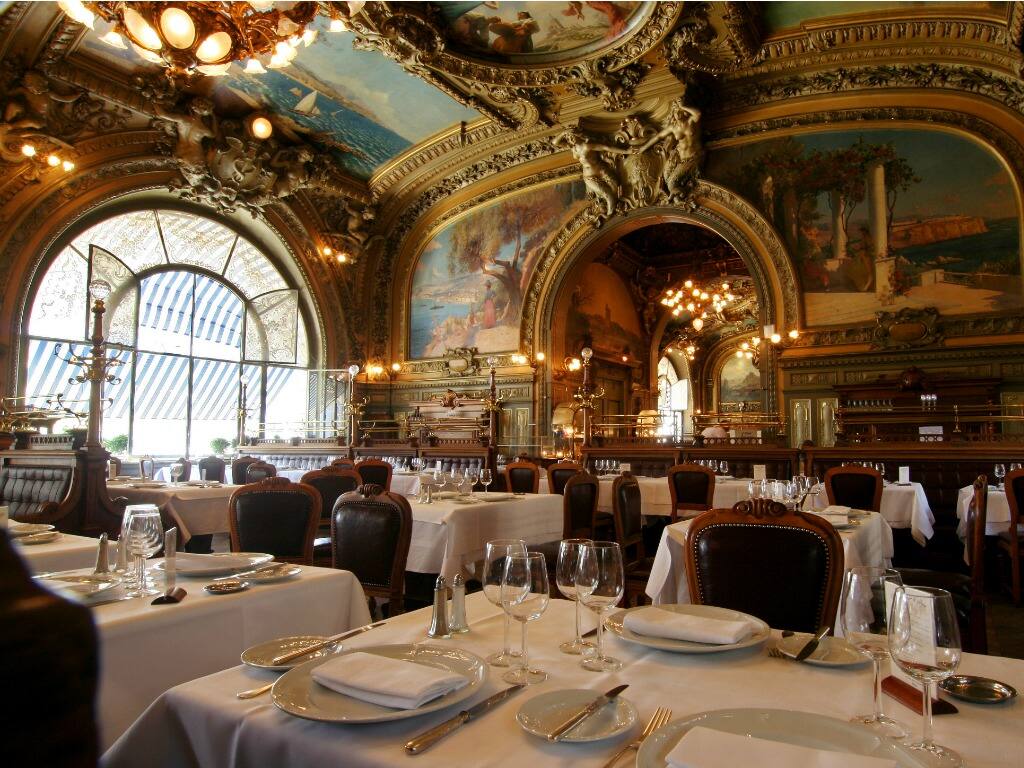 the ornate interior of the le train bleu restaurant in paris