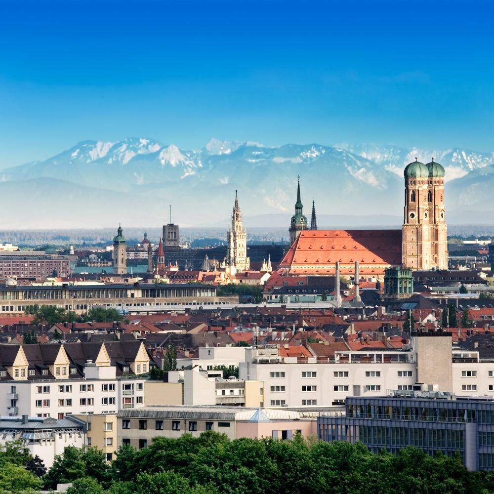 city skyline of munich with alps in the background