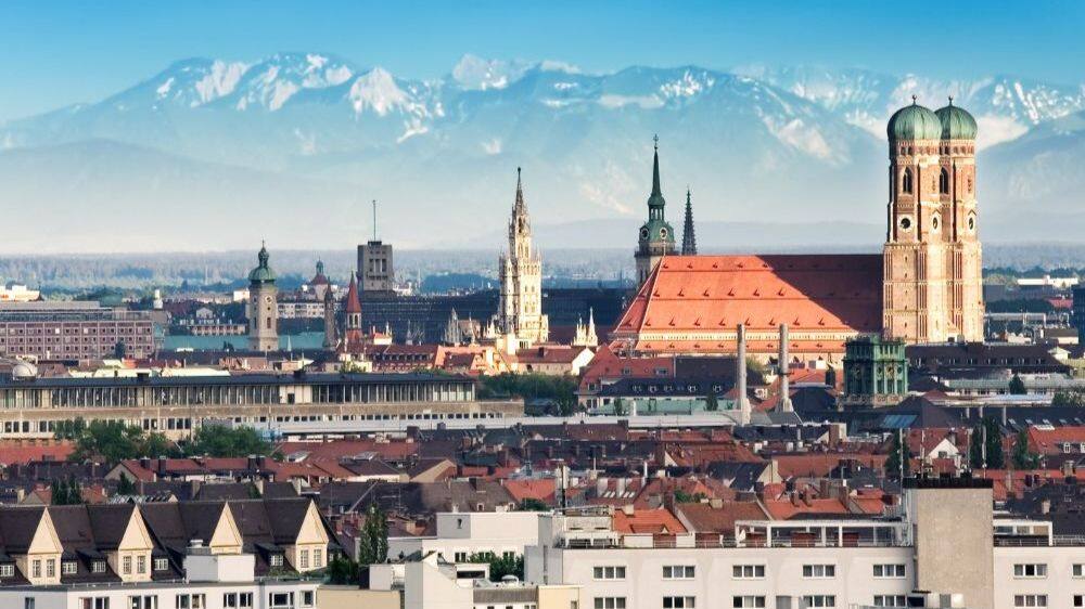 munich city skyline in the evening light with the alps visible in the background 