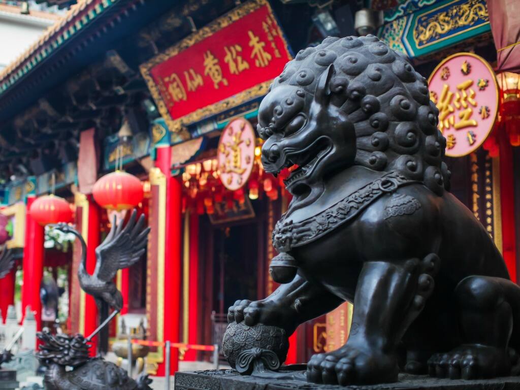 ornate lion sculpture outside a temple in kowloon in hong kong