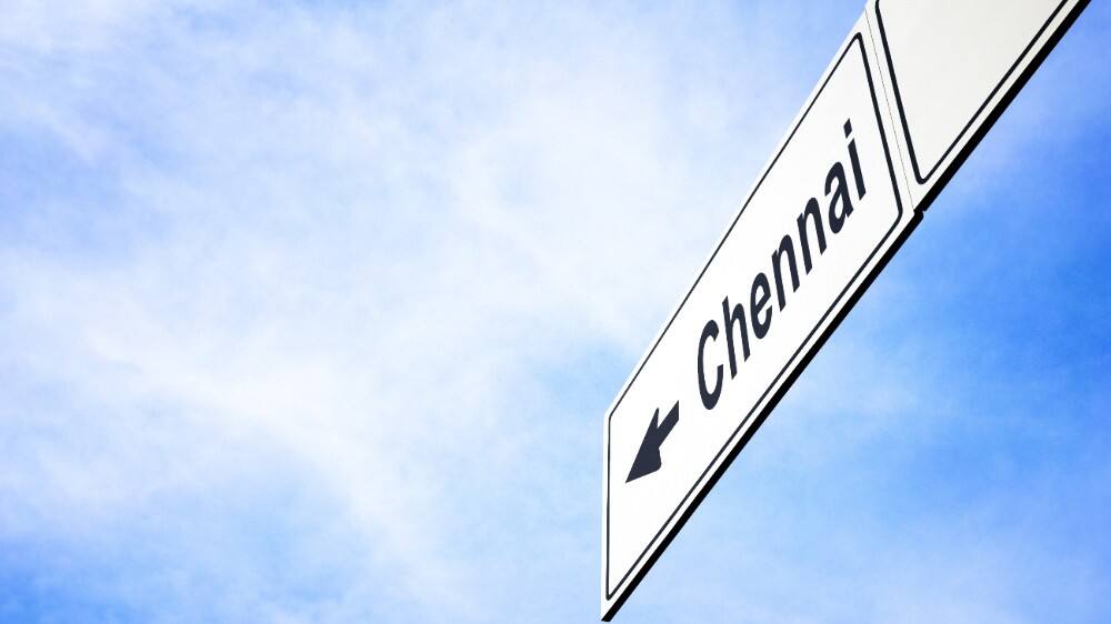white signboard pointing toward chennai