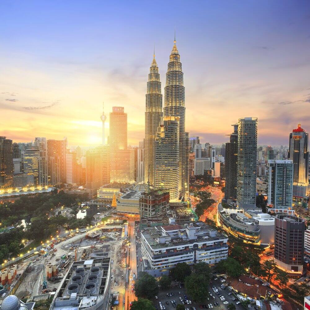 a view of the petronas towers in kuala lumpur at sunset