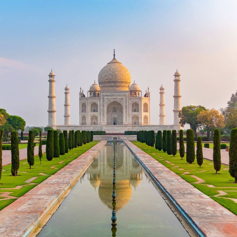 front view of taj mahal and reflecting pool in india
