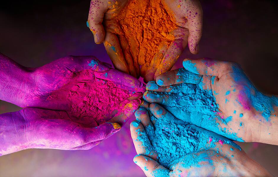 colourful hands covered in holi powder in india