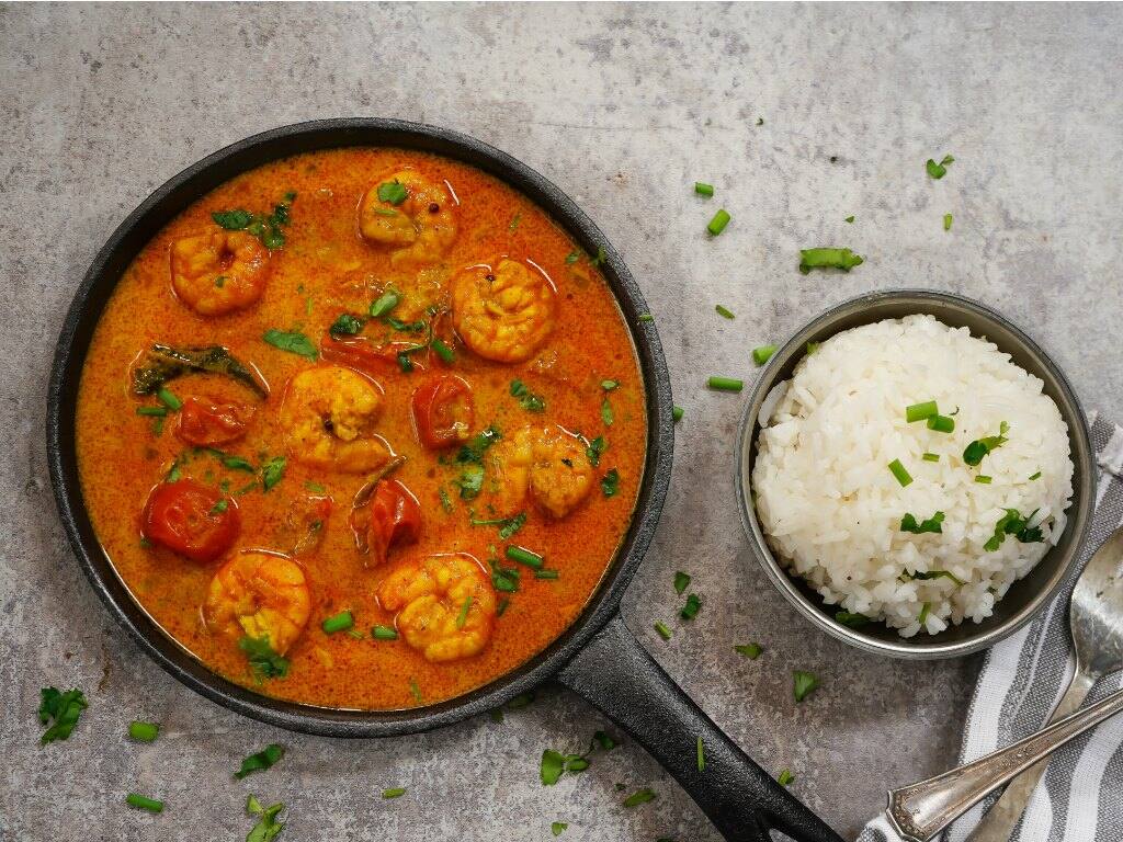 prawn in coconut curry dish with rice in kochi india