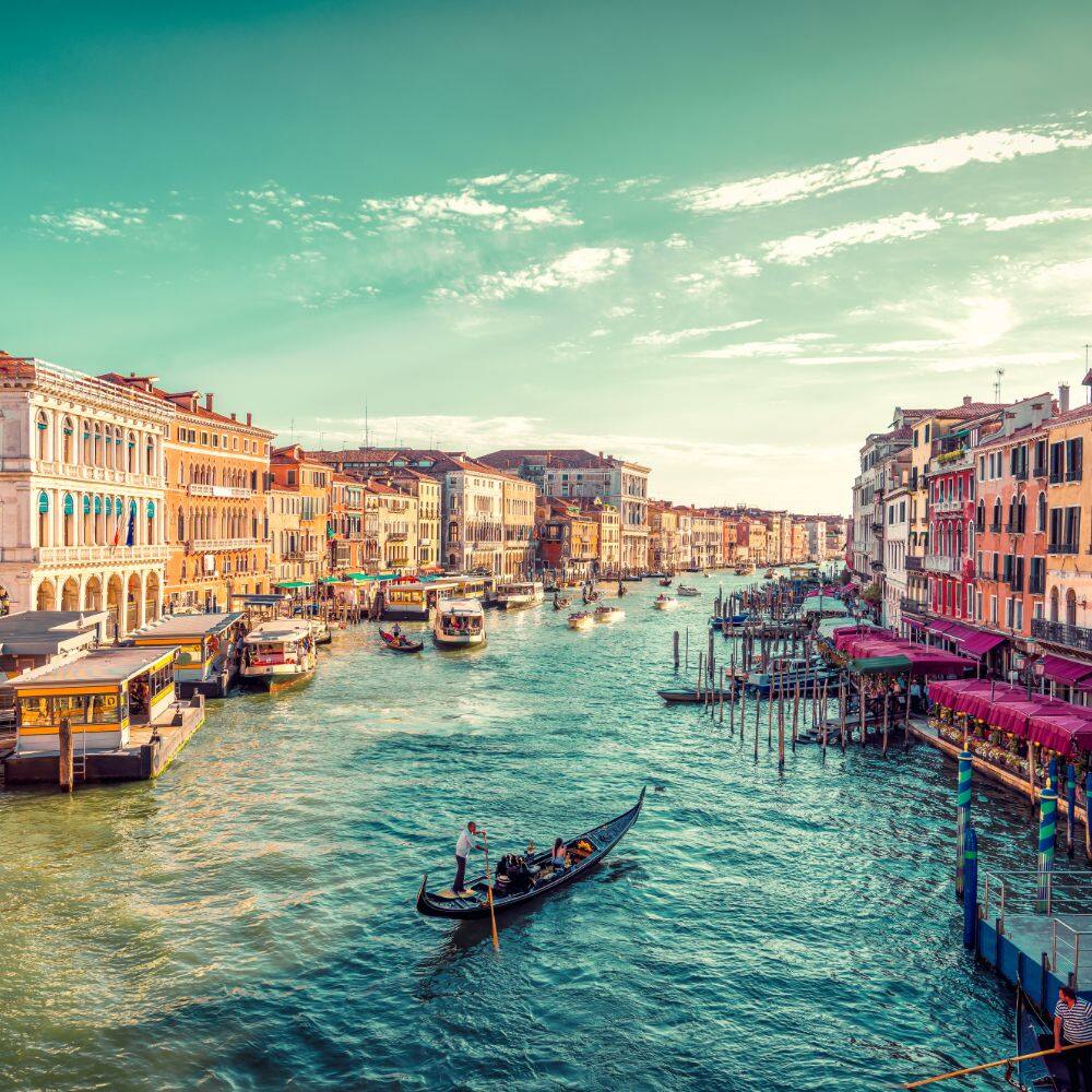 scenic view of boat on venice grand canal and houses in Italy