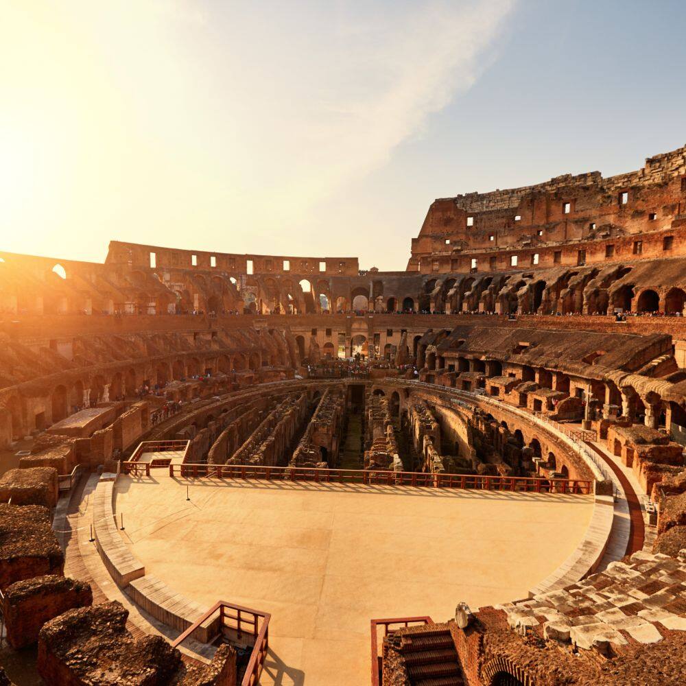 view of inside the coloseum at sunset in rome