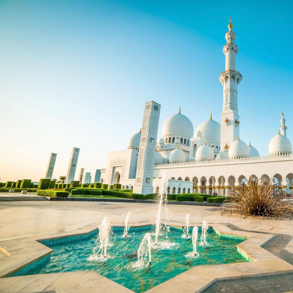 fountain and blue sky at the sheikh zayed grand mosque abu dhabi uae