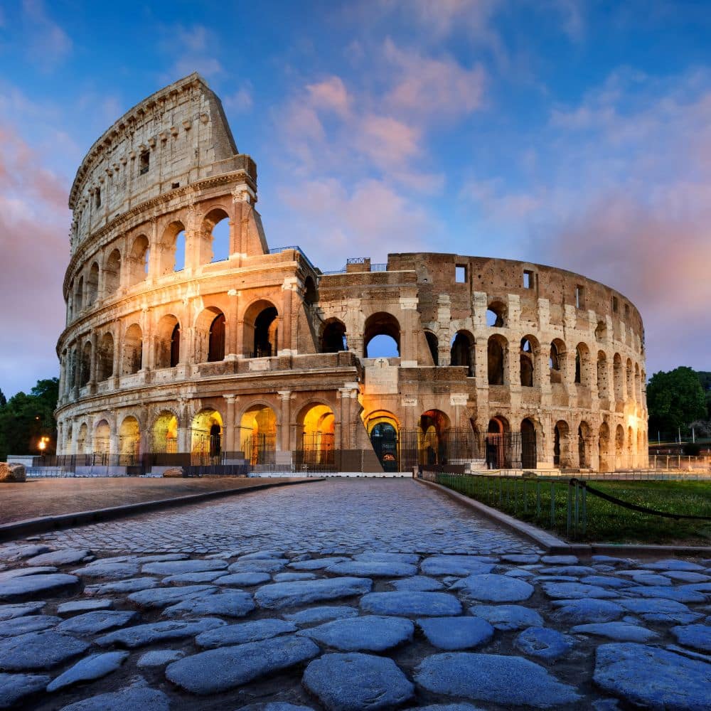 the outside of the colesseum at dusk rome italy