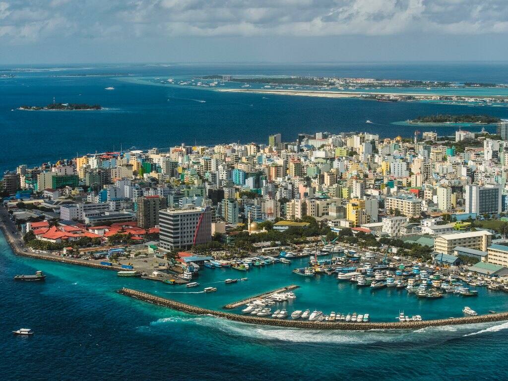 an aerial view of the island of male in the maldives showing buildings and its harbour