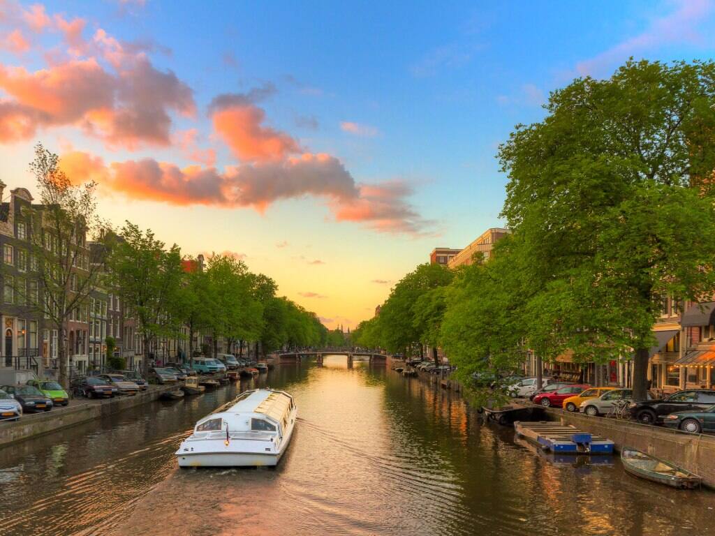 amsterdam canal boat at sunset