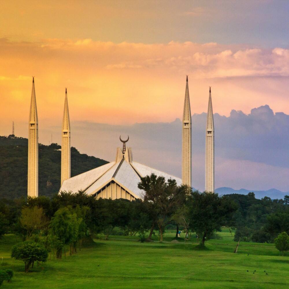 orange skies and shah faisal mosque in pakistan
