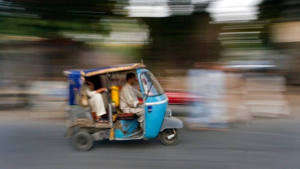 tuk tuk in motion as a form of transportation in pakistan