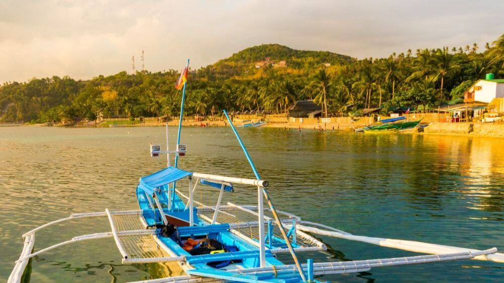 view of a boat on water and the coastline philippines