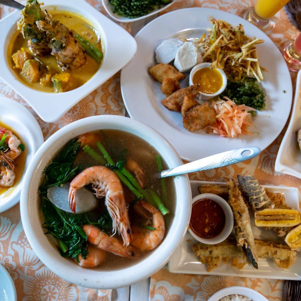 variety of traditional philippino dishes including a seafood soup 