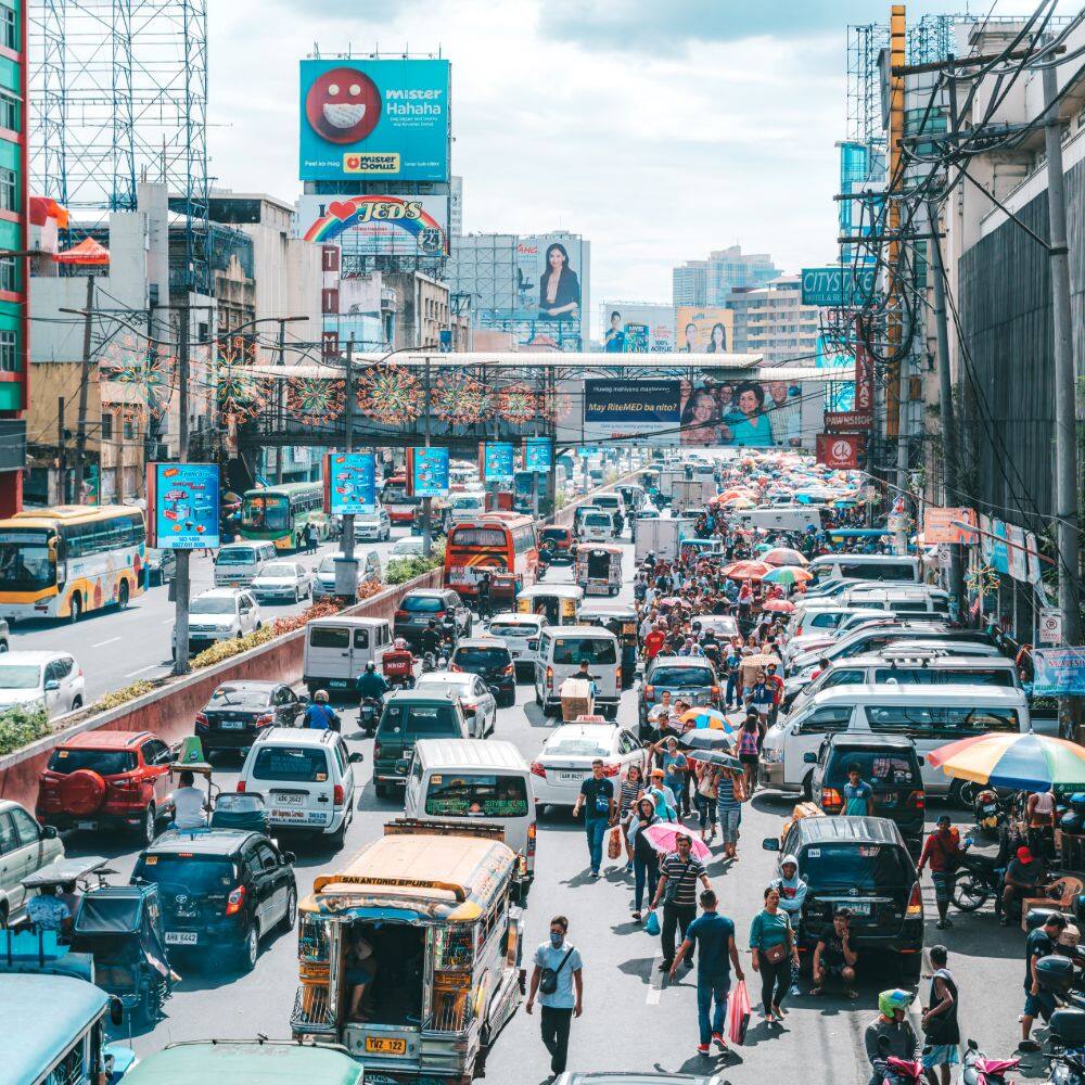 a busy street full of cars in manila