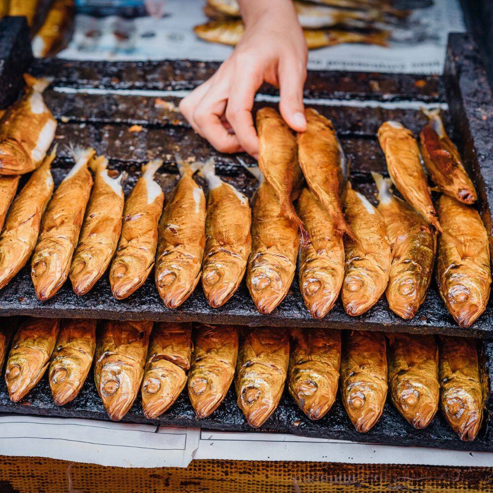 fish lined up on a barbecue in manila 