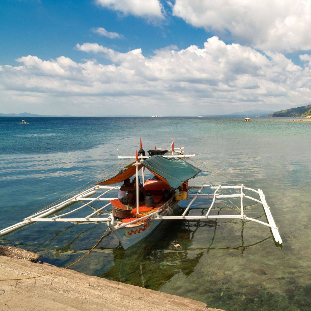 a boat approaching the coast manila 