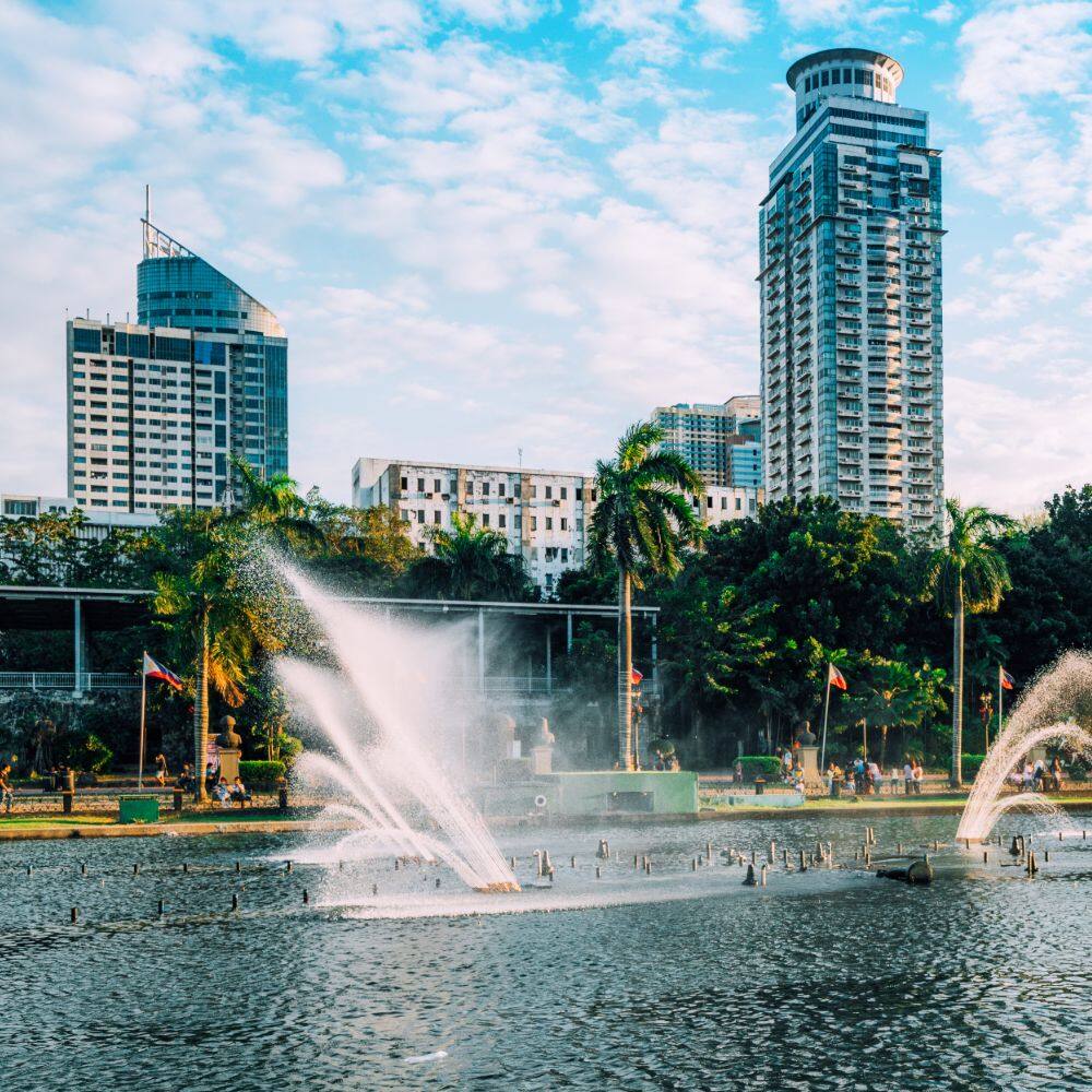 water fountains with sky scrapers in the background in manila