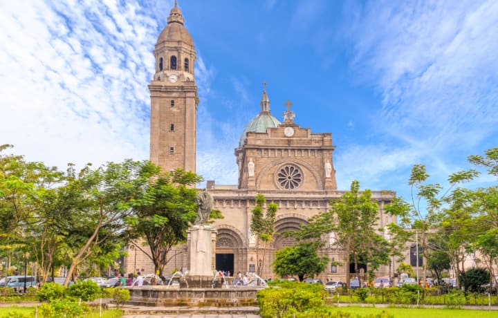 a sunny day over the cathedral of manila and basilica located in intramuros