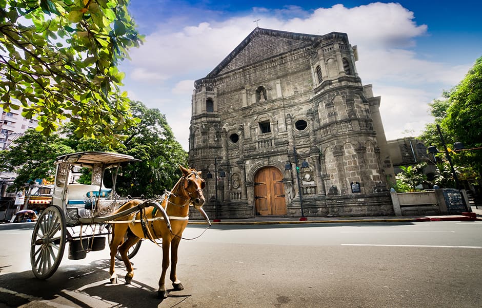 horse drawn carriage in front of malate church manila philippines