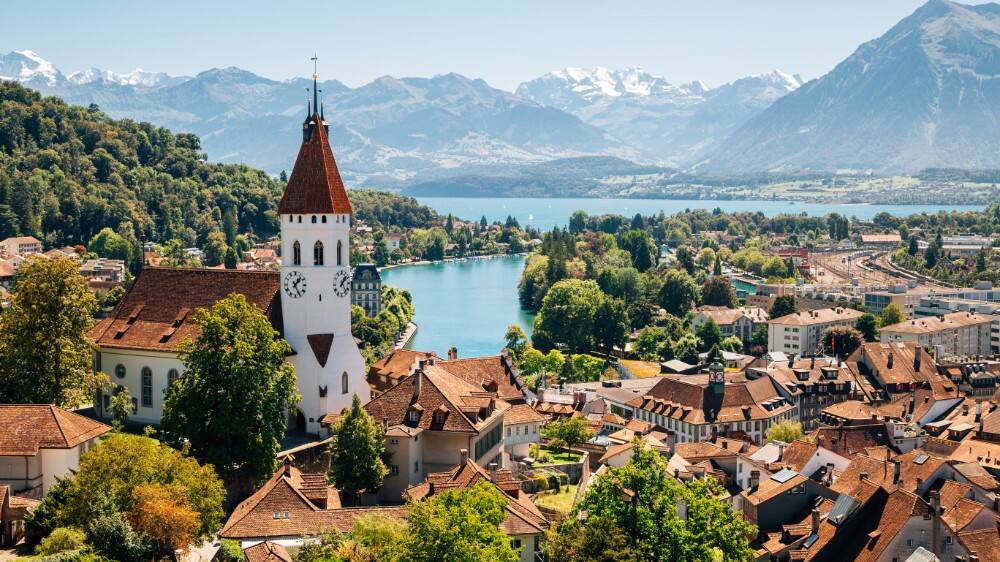 scenic thun cityspace greenery with snowy alp mountains and lake in switzerland 