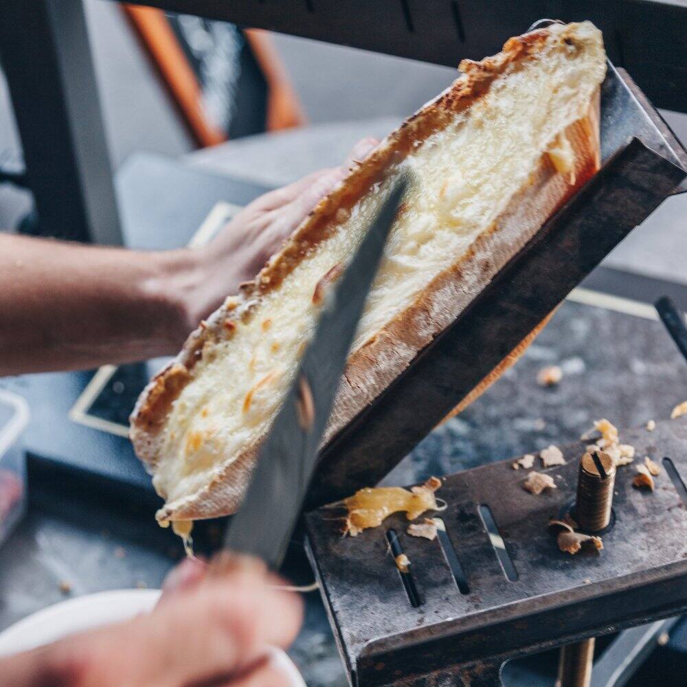 melted grilled cheese at a local street food market in switzerland 