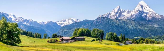 scenic view of switzerland landscape with lake and snowy mountains in the distance 