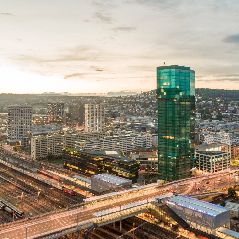 view of the lit up prime tower and skyline in switzerland
