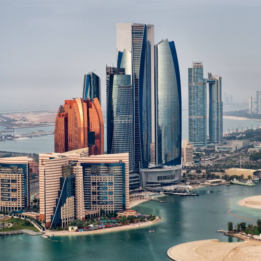 helicopter point of view of abu dhabi skyline with surrounding area