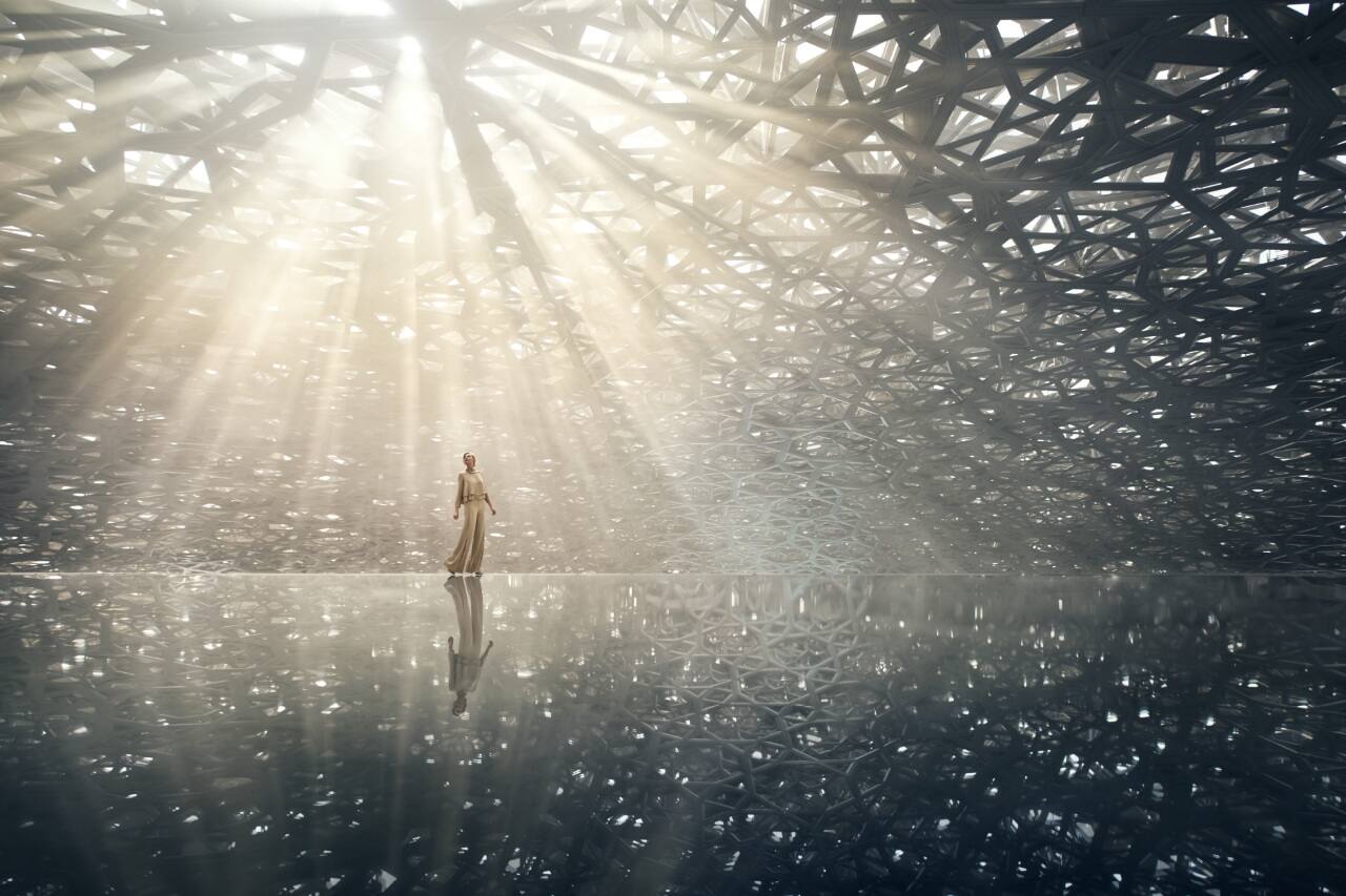 two people standing inside the louvre in abu dhabi