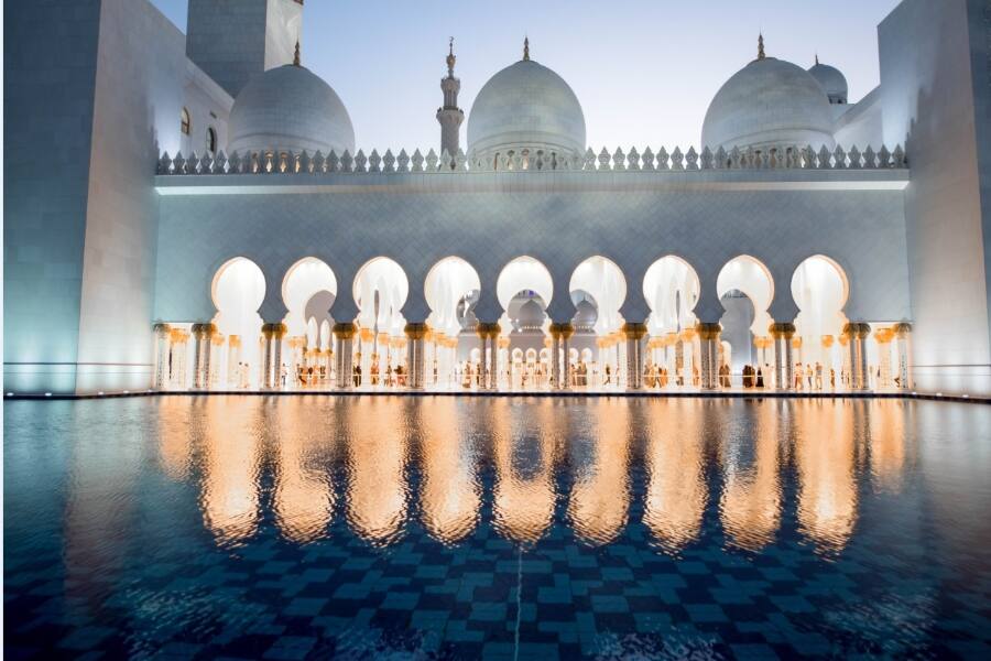 view of sheikh zayed grand mosque lit up inside