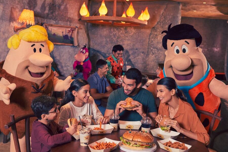 family dining with the flintstones at warner bros world in abu dhabi